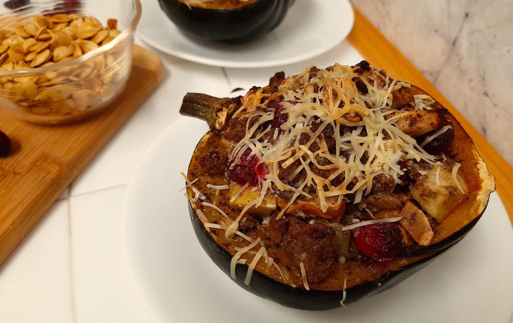Fall Stuffed Acorn Squash with italian beef sausage, celery, cranberries, winesap apples, toasted almonds, squash seeds, honey goat cheese, sage, allspice, and cloves topped with parmesan.