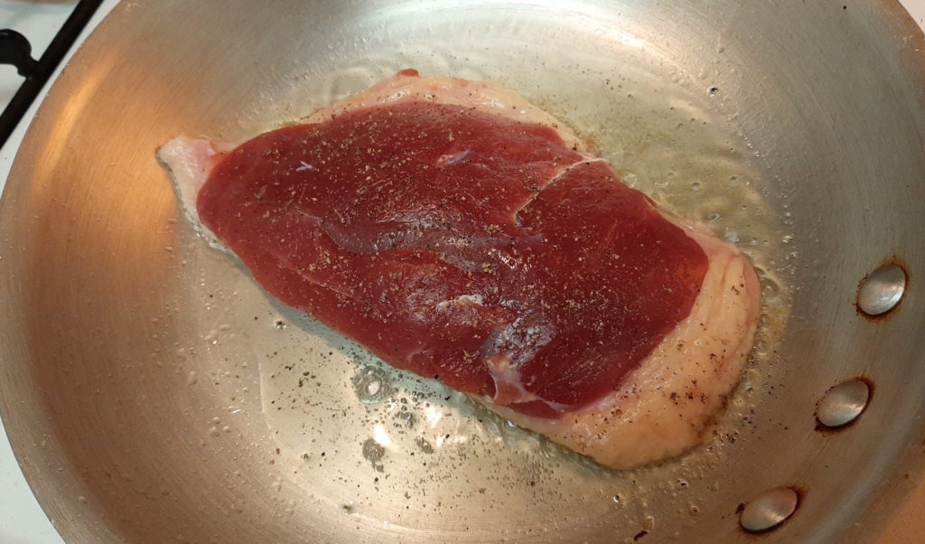 Pan-seared Duck Breast, skin-side down in a cold pan, reducing fat in the skin and forming a crust.