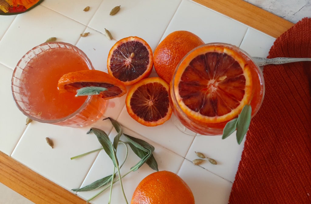 Sage and Blood Orange Fizz. Fall cocktail with sage and cardamom simple syrup, gin, brandy, bourbon, prosecco, blood orange juice. Thanksgiving big batch cocktail.