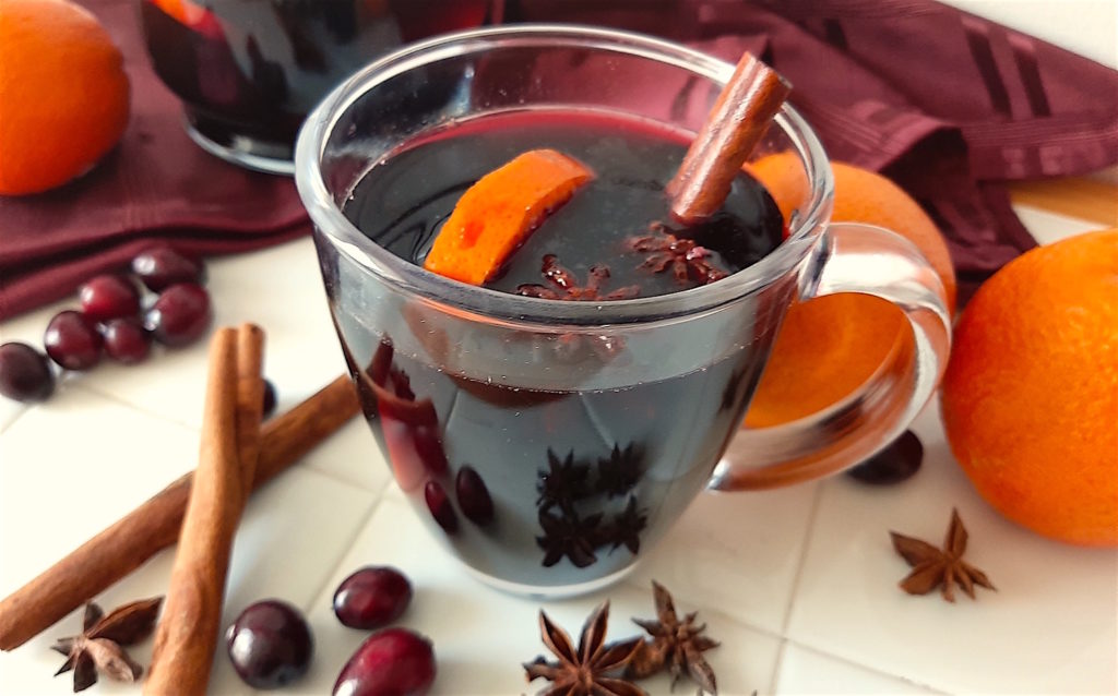 Mulled Red Wine with Oranges, Star Anise, Cinnamon, and Cranberries. Surrounded by Oranges, Star Anise, Cinnamon, and Cranberries. Thanksgiving Cocktail, Winter Cocktail, Christmas Cocktail, Fall Cocktail, Big Batch Cocktail.