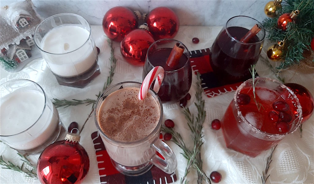 Christmas cocktails on display with Christmas decorations and cranberries.