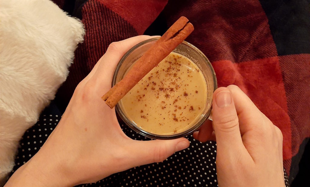 Cozying up in a red plaid blanket with Hot Buttered Rum made with Chairman's Reserve rum, brown sugar, vanilla extract, cinnamon, allspice, cloves, and nutmeg.
