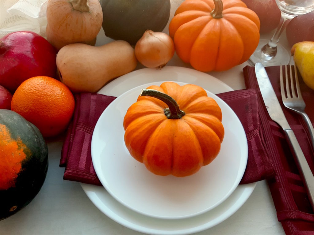 Fall Dinner with pumpkins, butternut, oranges, pomegranates, and acorn squash.