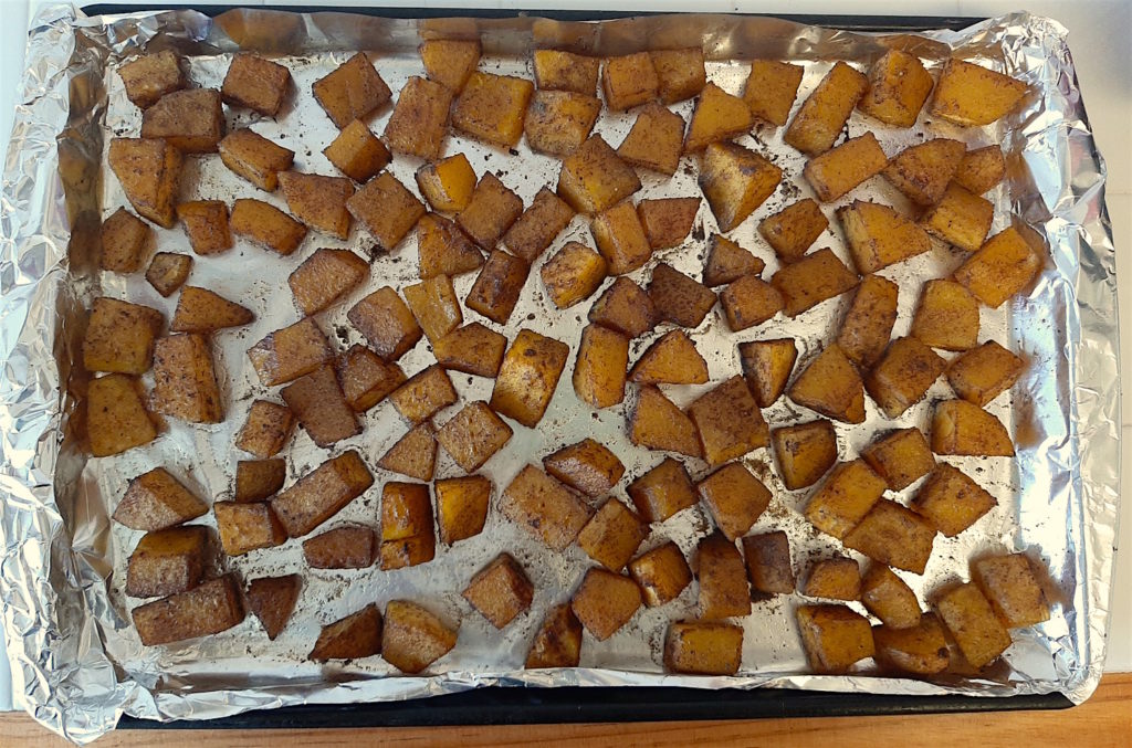 Cookie sheet of roasted, seasoned cardamom butternut squash just out of the oven.