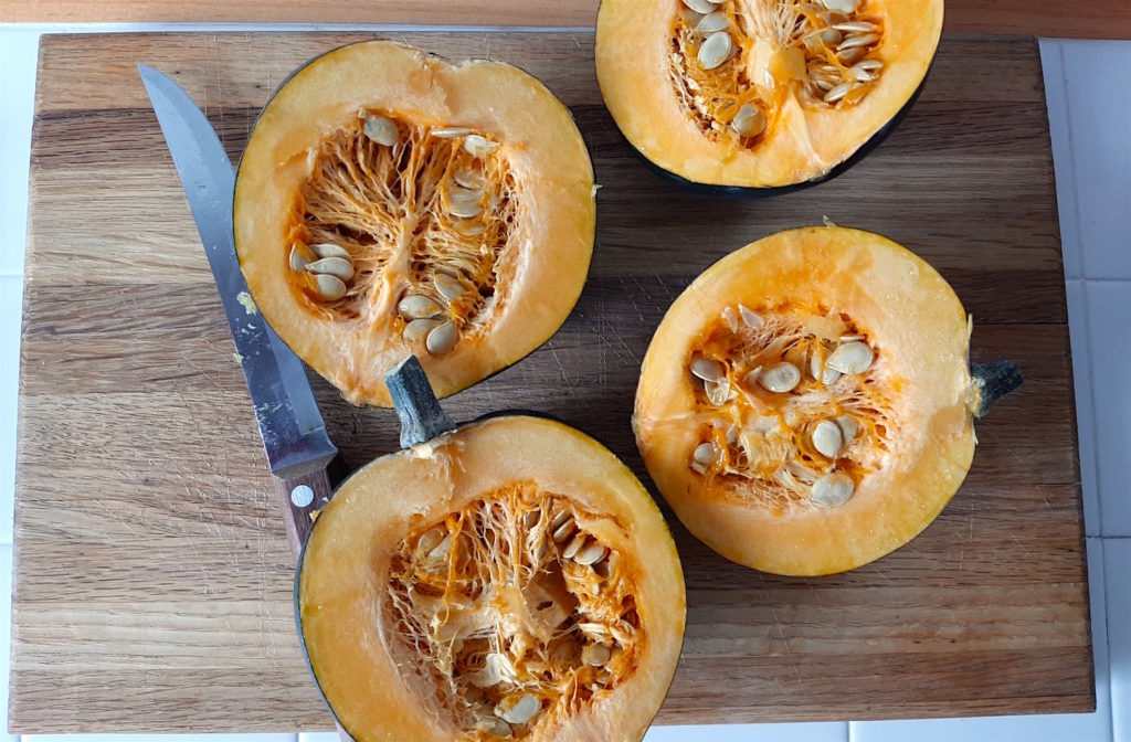 Acorn Squash sliced in half with seeds exposed.