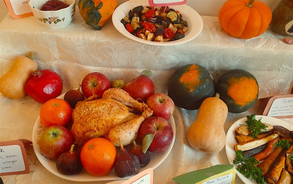 Fall Dinner Spread with food labels. Roast Chicken with apples, oranges, and figs. Roast Vegetables, Decorative Squashes, Acorn Squash, Butternut, Kabocha, Pomegranate, Pumpkins, Cranberry Sauce