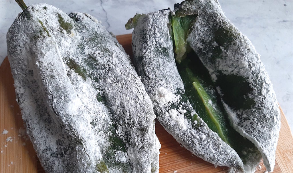 Sliced poblano peppers coated in flour waiting for stuffing. Sugar with Spice Blog