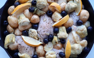 Oven Roasted Chicken Thighs with Potatoes, Artichokes, Olives, Lemon, Wine and Chicken Broth in a large Cast Iron Skillet