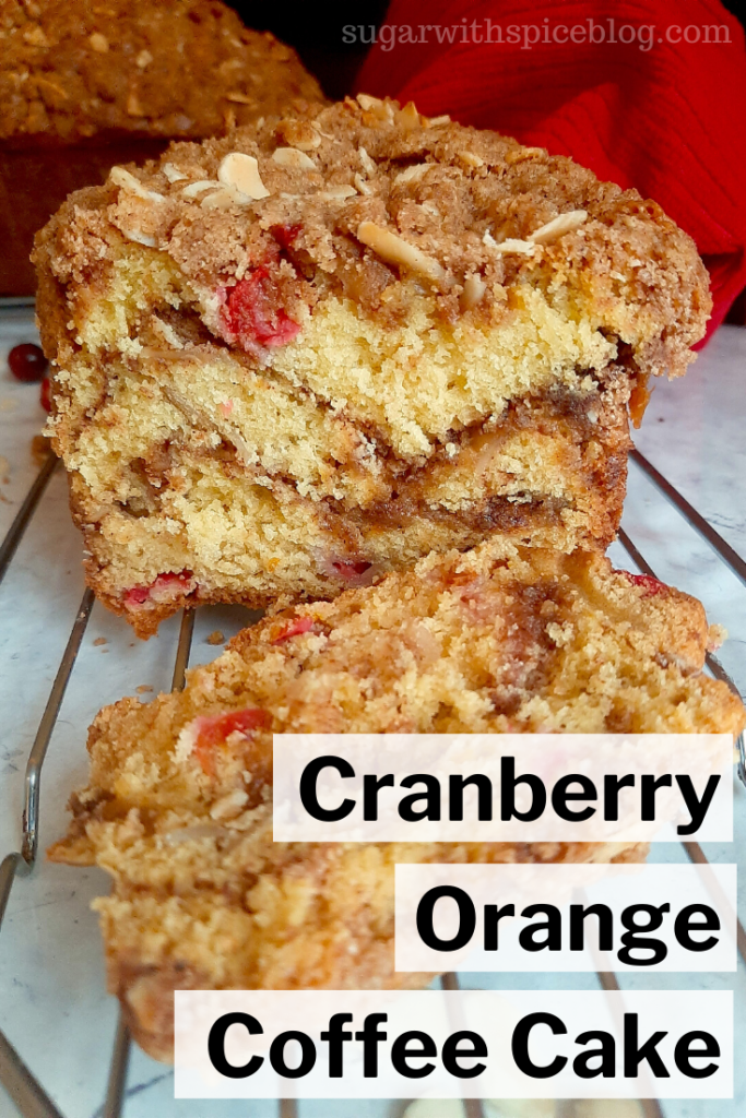 Cranberry Orange Coffee Cake cooling on a rack on a marble surface with red tea towel in the background. Sugar with Spice Blog