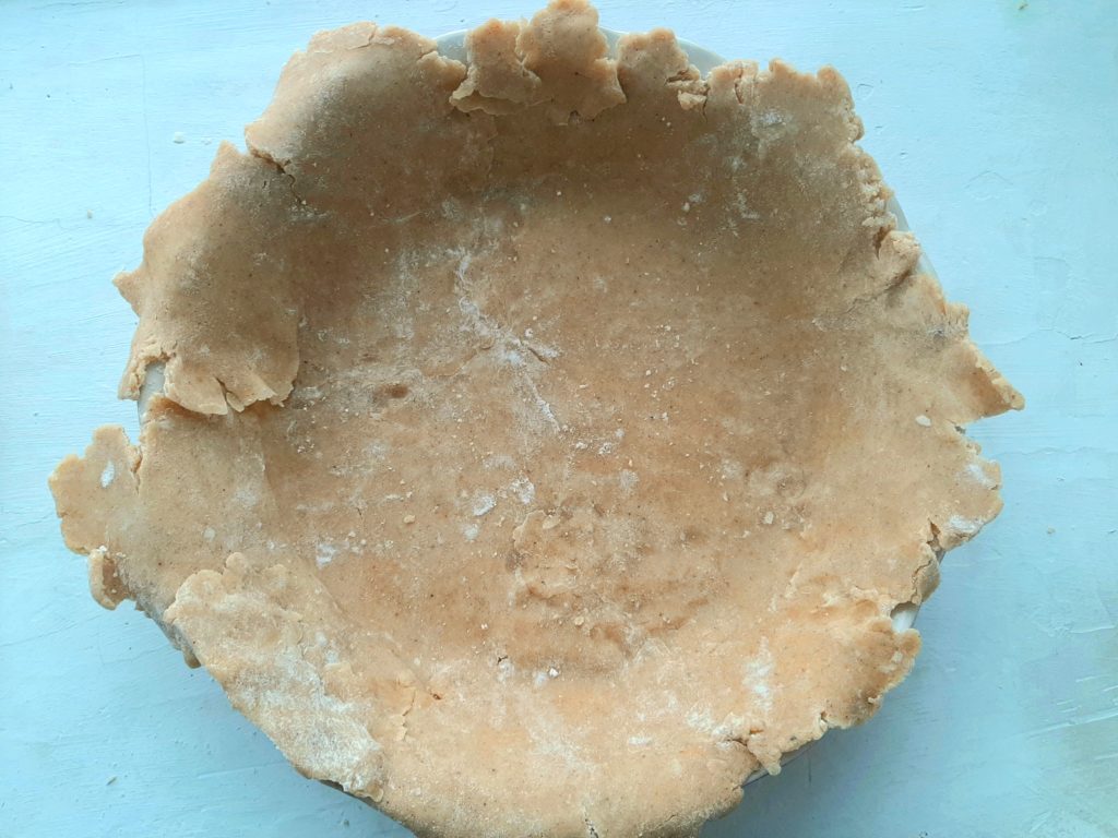 Spiced all-butter pie crust unshaped and in ceramic pie dish. Sugar with Spice Blog