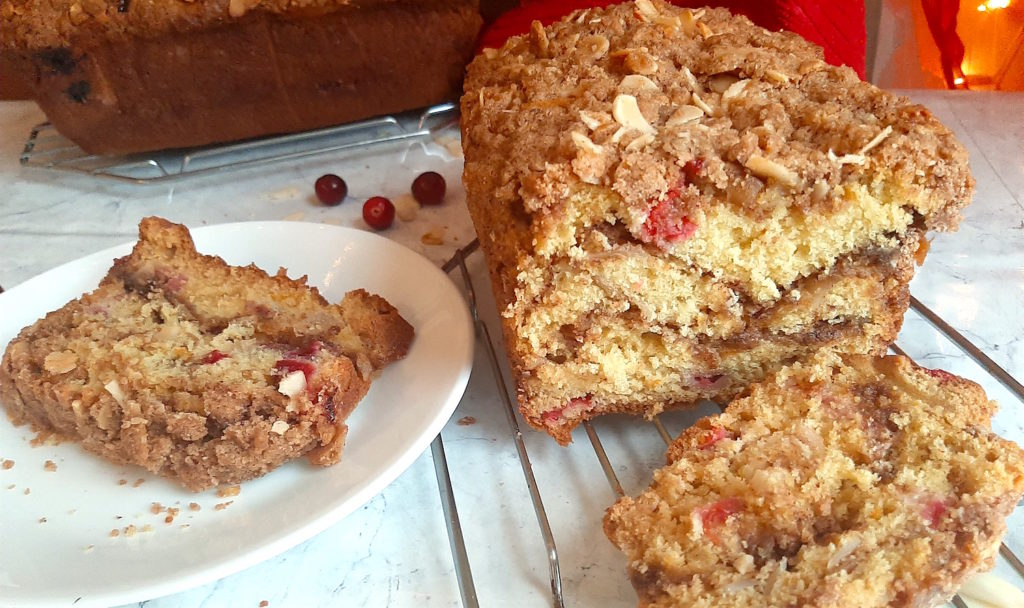 Cranberry Orange Coffee Cake sliced with Almonds and brown sugar. Sugar with Spice
