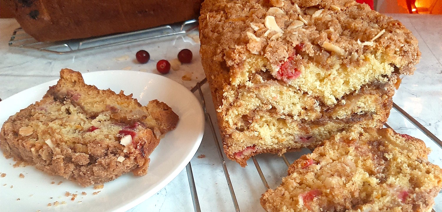 Cranberry Orange Coffee Cake sliced with Almonds and brown sugar. Sugar with Spice