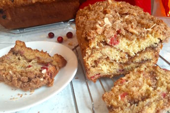 Cranberry Orange Coffee Cake sliced with Almonds and brown sugar. Sugar with Spice