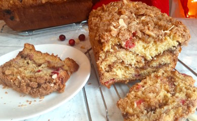 Cranberry Orange Coffee Cake sliced with Almonds and brown sugar. Sugar with Spice