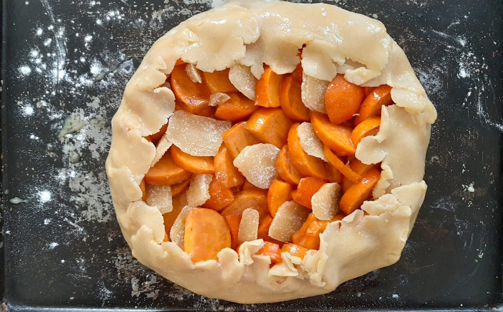 Persimmon and ginger galette, raw, on a baking sheet ready to go in the oven. Sugar with Spice Blog
