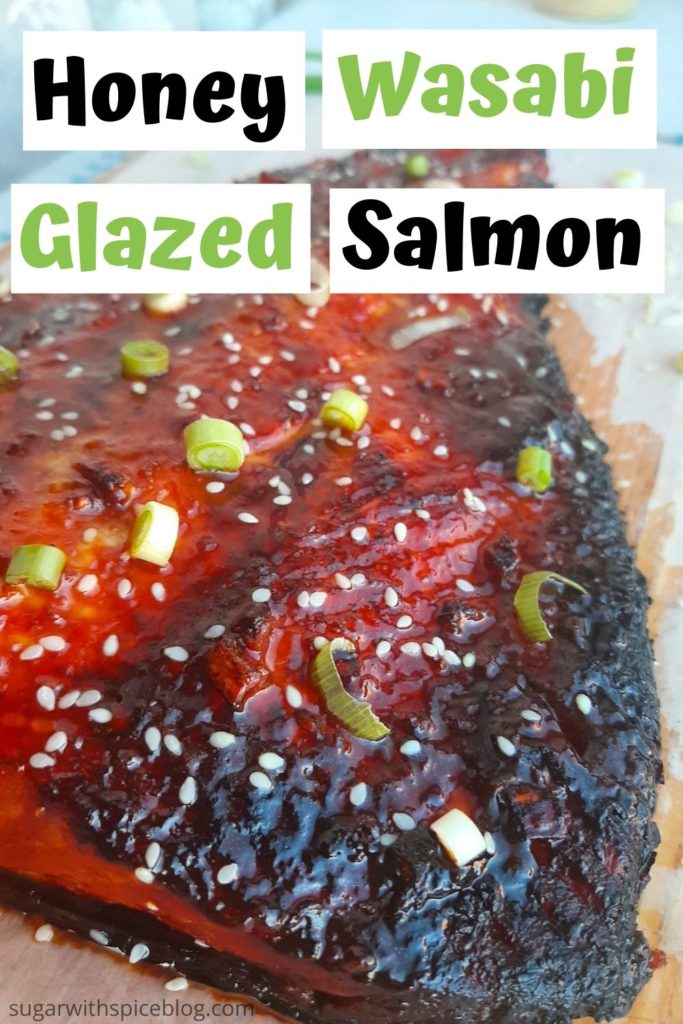 Honey Wasabi Glazed Salmon on a wooden cutting board garnished with green scallions and sesame seeds. Sugar with Spice Blog.