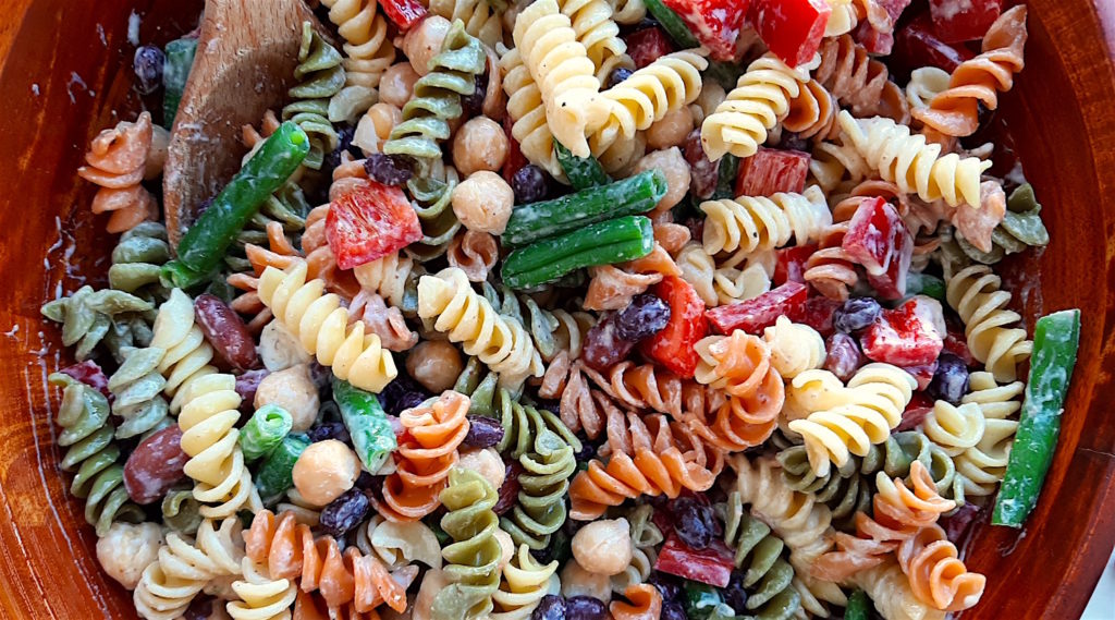 Three Bean Pasta Salad with lemony mustard dressing Sugar with Spice Blog. Overhead close up shot of Three Bean Pasta Salad in a big wooden salad bowl and wooden spoon.