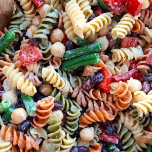 Three Bean Pasta Salad with lemony mustard dressing Sugar with Spice Blog. Overhead close up shot of Three Bean Pasta Salad in a big wooden salad bowl and wooden spoon.