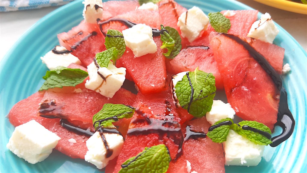 Watermelon and Mint Salad with feta and balsamic reduction on a blue plate. Close up shot. Sugar with Spice Blog.