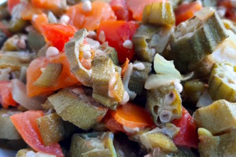 Southern Sautéed okra with onions, garlic, and tomatoes, Close Up Shot in white bowl. Sugar with Spice Blog.