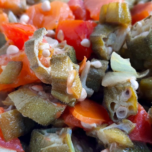 Southern Sautéed okra with onions, garlic, and tomatoes, Close Up Shot in white bowl. Sugar with Spice Blog.