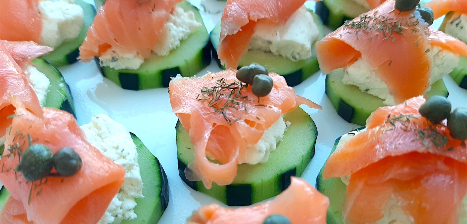 Cucumber Smoked Salmon Bites on a white serving tray with boursin cheese, capers, and smoked salmon. Close up shot. Sugar with Spice Blog.