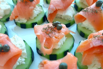 Cucumber Smoked Salmon Bites on a white serving tray with boursin cheese, capers, and smoked salmon. Close up shot. Sugar with Spice Blog.