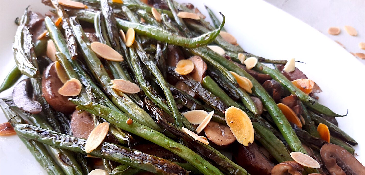 Almond and Mushroom Green Beans served on a white serving dish. Close Up shot. Sugar with Spice Blog.