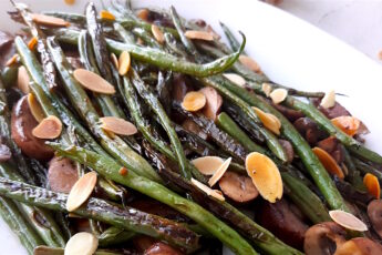 Almond and Mushroom Green Beans served on a white serving dish. Close Up shot. Sugar with Spice Blog.