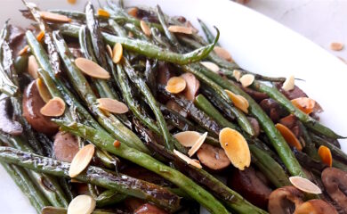 Almond and Mushroom Green Beans served on a white serving dish. Close Up shot. Sugar with Spice Blog.