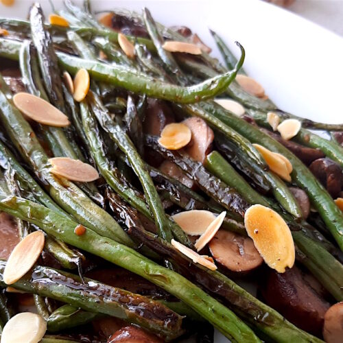 Almond and Mushroom Green Beans served on a white serving dish. Close Up shot. Sugar with Spice Blog.